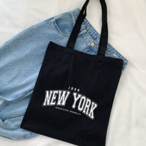 1 pièce Sac fourre-tout en canevas noir à la mode avec imprimé de lettre 1989newyork, avec une bandoulière simple pour femmes, sac de courses portable, sac à livres prep pour la semaine du livre